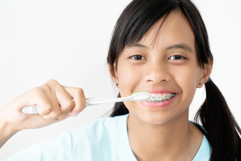 a girl holding a toothbrush