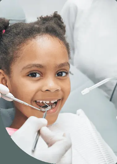 Smiling young girl receiving a dental check-up with orthodontic tools at Limestone Hills Orthodontics in Austin, TX.