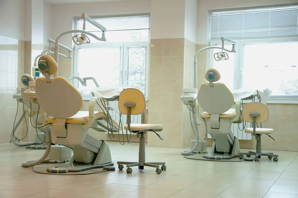 Modern dental office with chairs and equipment, showcasing advanced orthodontic technology and a clean and professional setting.