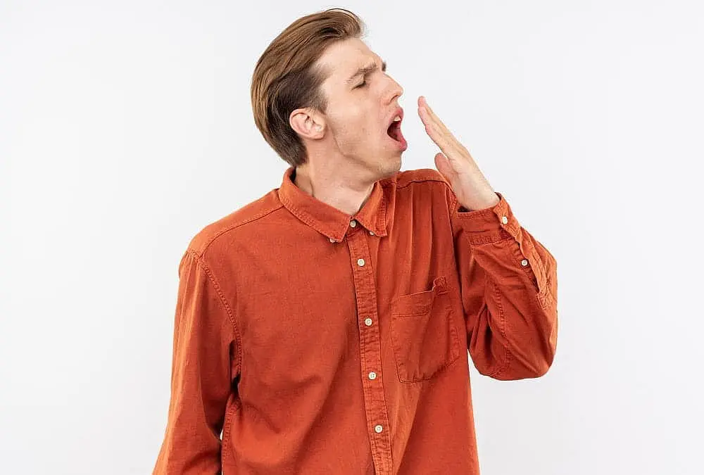 Young man demonstrating mouth breathing, illustrating its relationship to the development of an underbite, explained at Limestone Hills Orthodontics in Austin, TX.