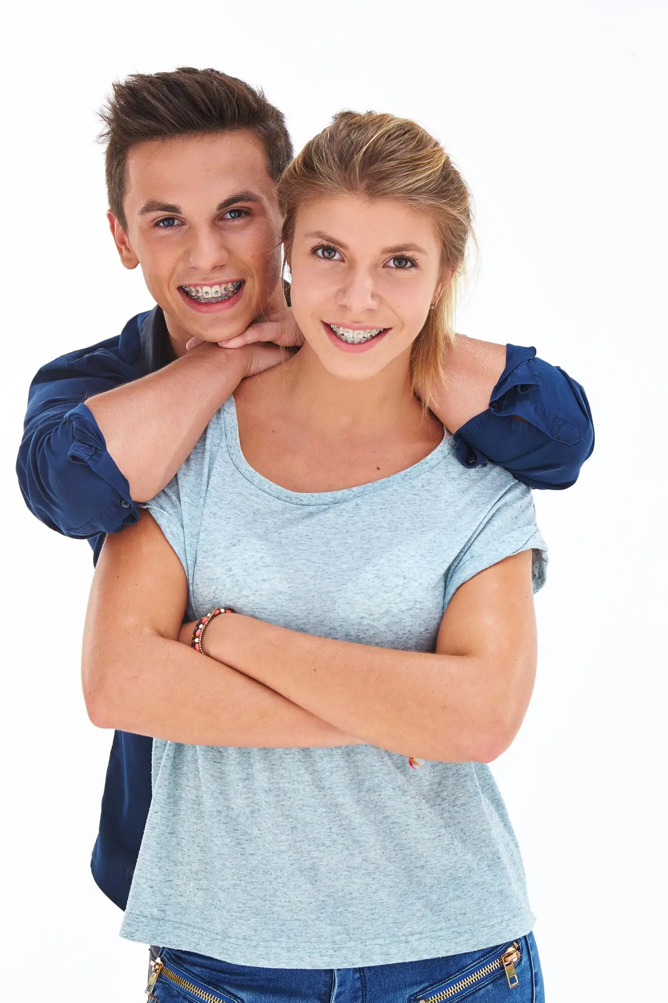 Smiling teenage boy and girl wearing braces, representing teen orthodontic care at Limestone Hills Orthodontics in Austin, TX.