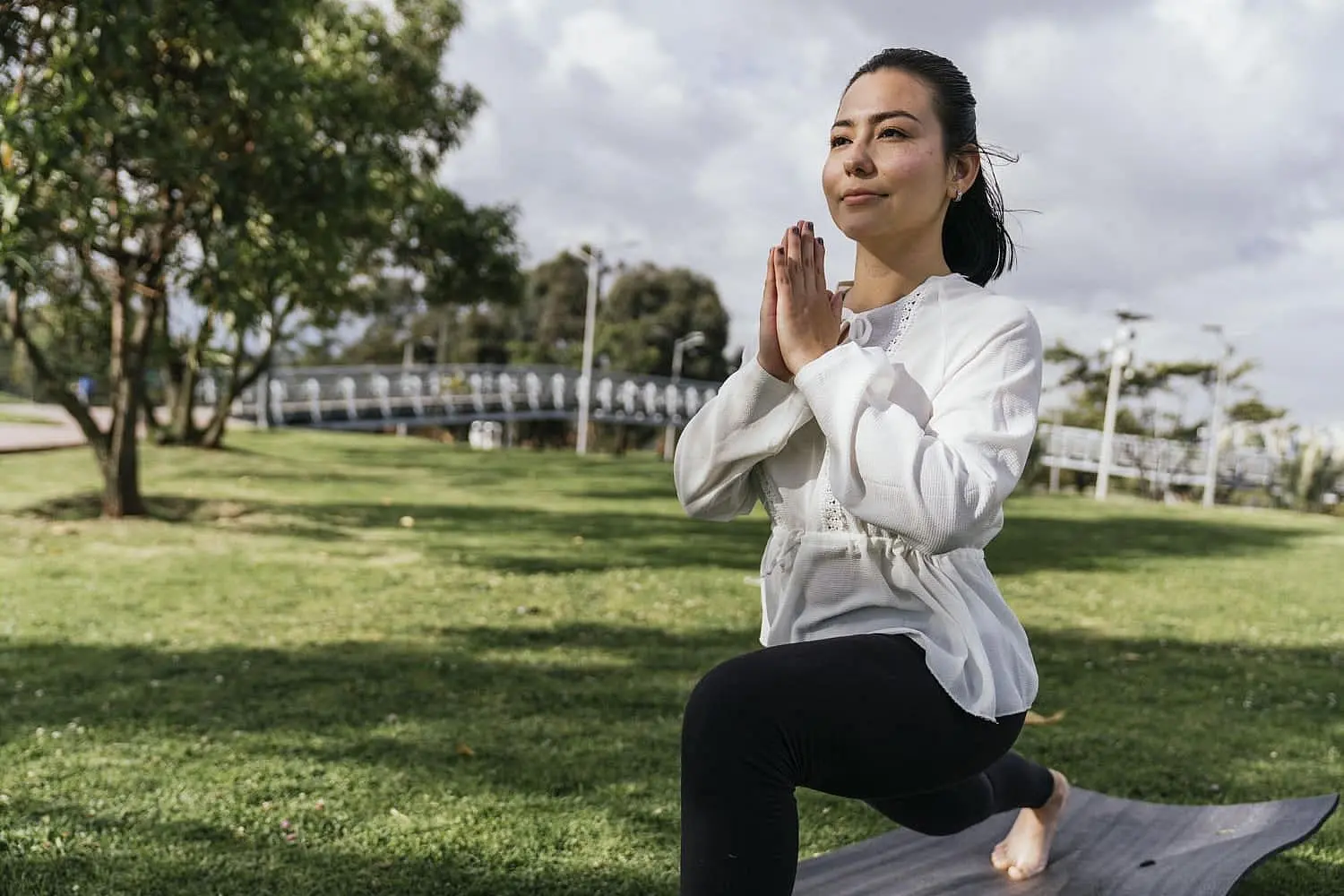 Woman practicing yoga outdoors, representing healthy lifestyle choices that help in the prevention and management of mouth breathing. Limestone Hills Orthodontics in Austin, TX provides guidance on managing mouth breathing.