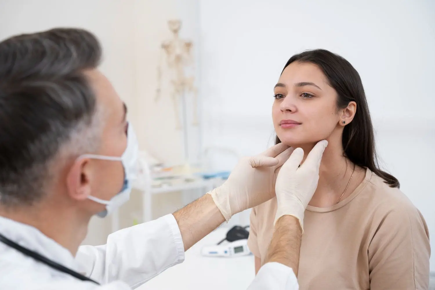 A medical professional examining a patient’s jaw during an orthognathic surgery consultation at Limestone Hills Orthodontics in Austin, TX.