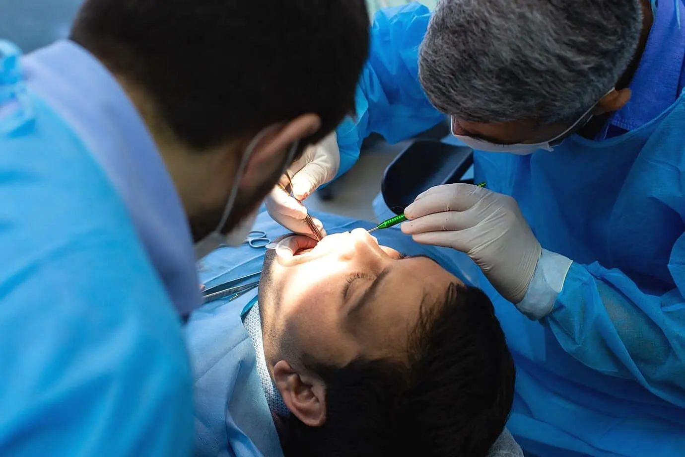 Dentist examining a patient’s open mouth to check for Symptoms and Diagnosis of Tongue Thrust at Limestone Hills Orthodontics in Austin, TX.