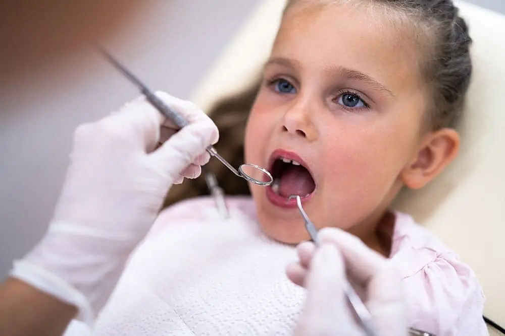Young girl receiving a pediatric orthodontic check-up for Tongue Thrust in Children at Limestone Hills Orthodontics in Austin, TX.