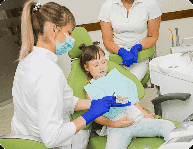 Dental professional shows a teeth model to a child at Limestone Hills Orthodontics in Austin, TX