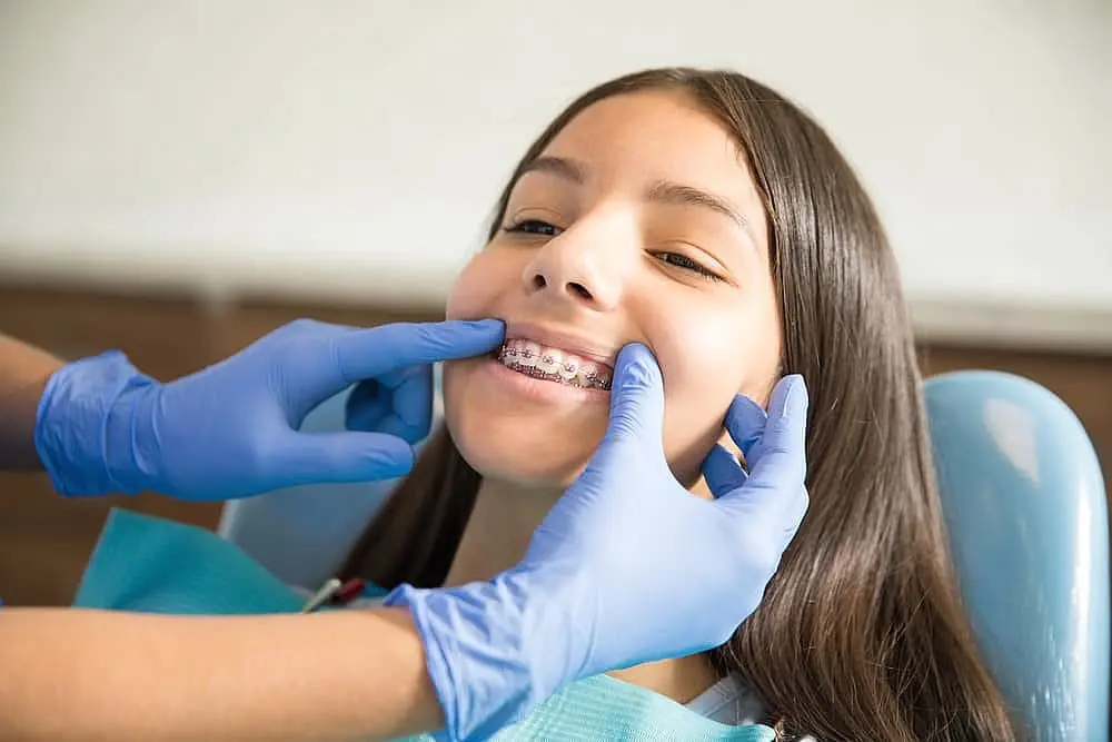 Young girl having her traditional braces checked at Limestone Hills Orthodontics in Austin, TX