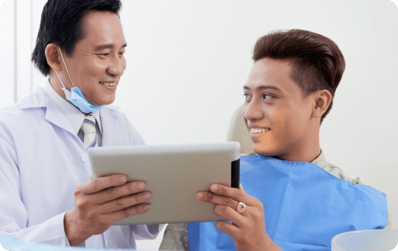 Orthodontist explaining the Benefits of Jaw Surgery to a young patient and parent during a consultation at Limestone Hills Orthodontics in Austin, TX.